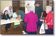 Dr. Alice Stewart and Gene Kendrick confer at the Senior Expo registration table.